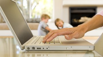 Hands of woman typing on laptop computer