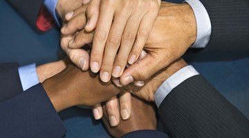 Businesspeople putting hands together