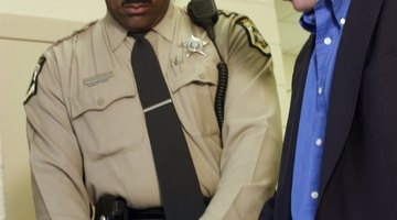 Police officer fingerprinting man