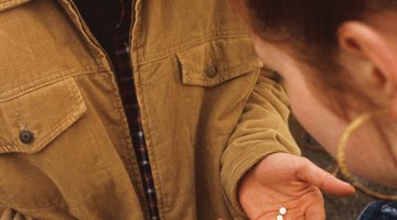 Teenagers (16-18) making drug deal, girl paying boy for pills