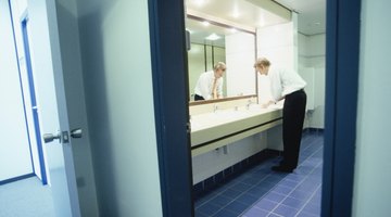 Businessman washing hands in bathroom