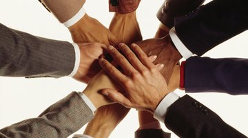 Hands of businesspeople in huddle
