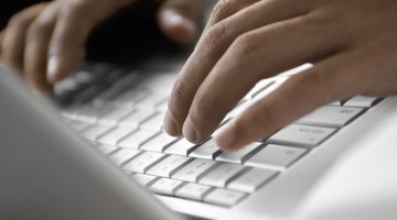 Close-up of a person operating a laptop