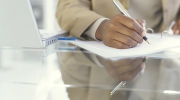 Businessman writing on document with fountain pen, close up