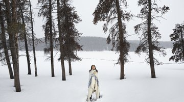 Young woman standing in snow, eyes closed