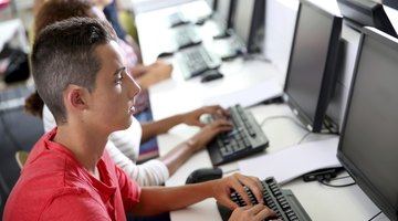 Serious student in front of computers at school