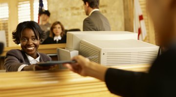 Clerk handing a file to someone in the courthouse