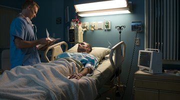 Doctor examining patient in hospital room