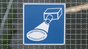 Surveillance sign on fence